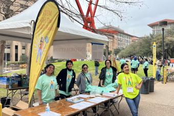 STEM Girl Day information tent with volunteers and STEM Girl Day coordinators in STEM Girl Day tshirts