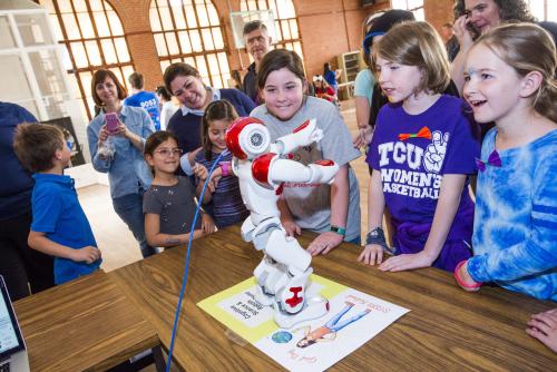 Girls exploring a robot at Girl Day