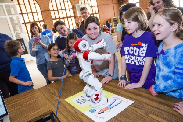 Girls exploring a robot at Girl Day